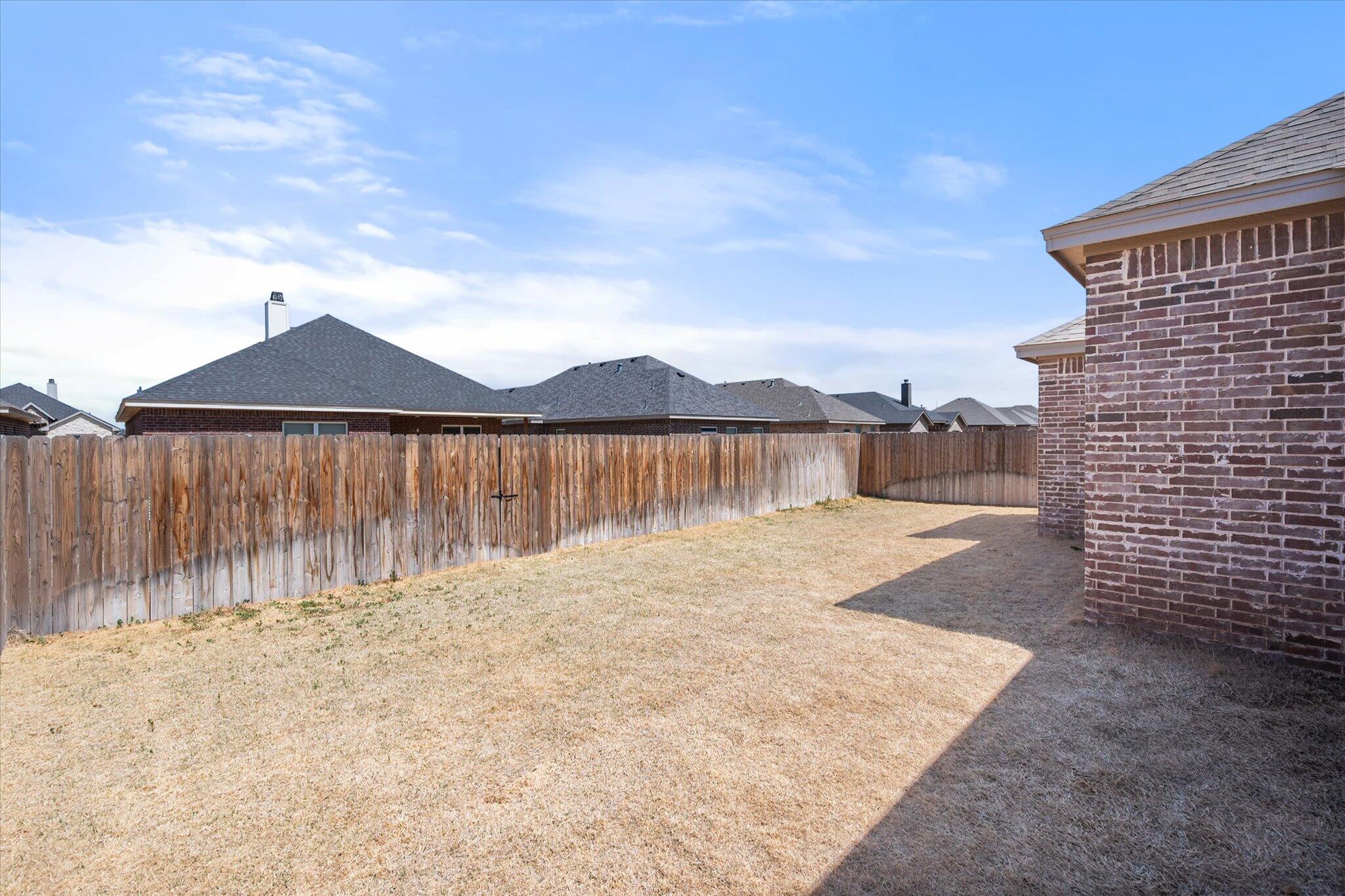 5908 Grinnell Street Lubbock, TX 79416 - Photo 25 of 27 a front view of a house with a yard