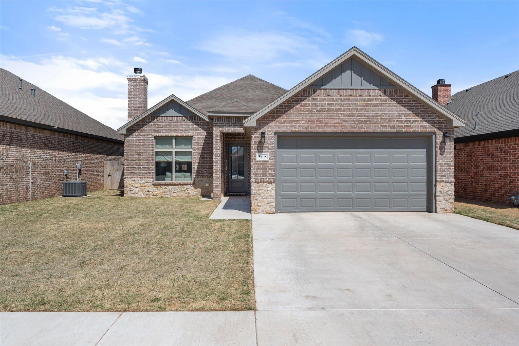 5908 Grinnell Street Lubbock, TX 79416 - Photo 27 of 27 a front view of a house with a yard and garage