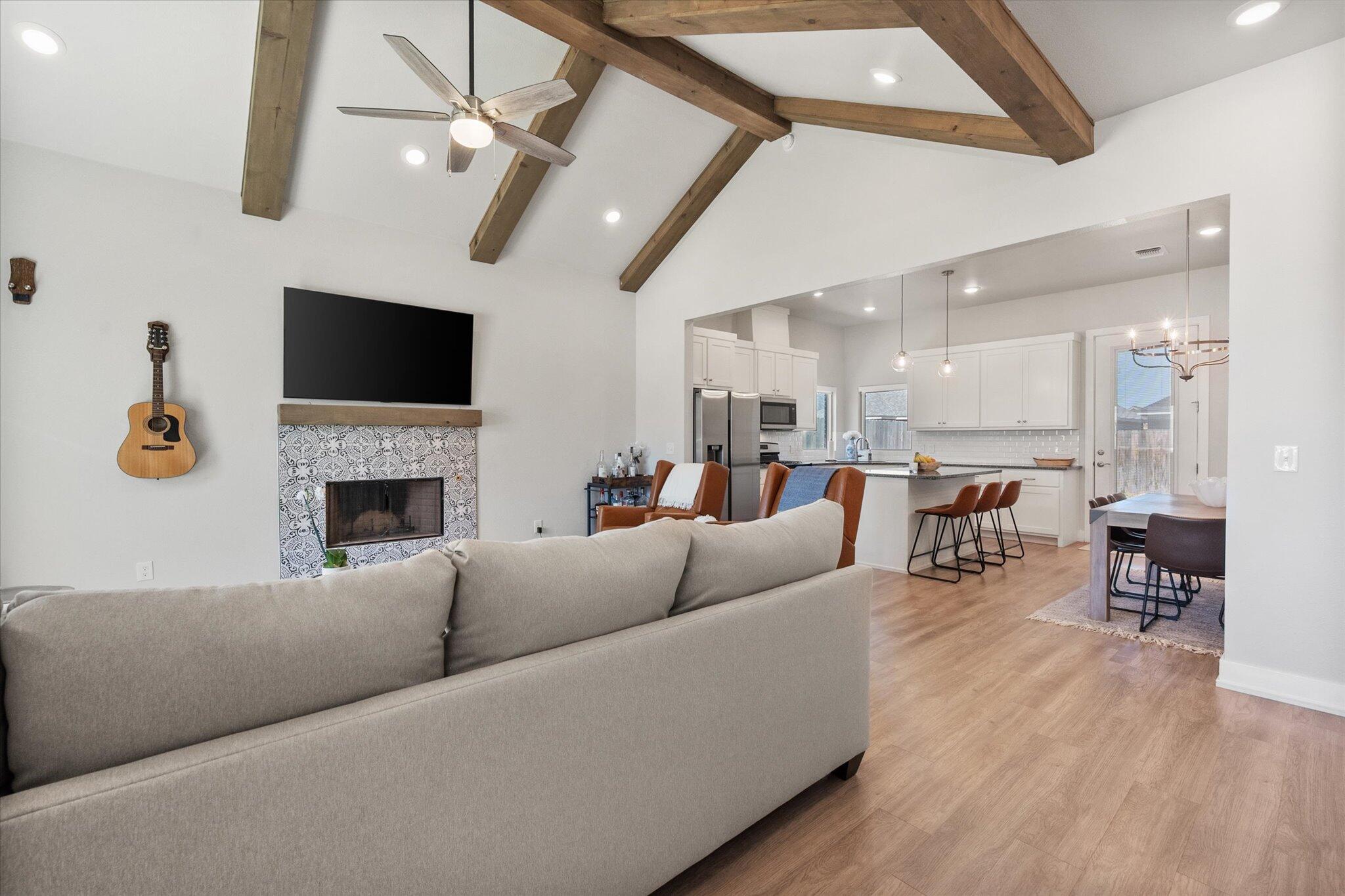 5908 Grinnell Street Lubbock, TX 79416 - Photo 4 of 27 a living room with furniture a fireplace and a flat screen tv