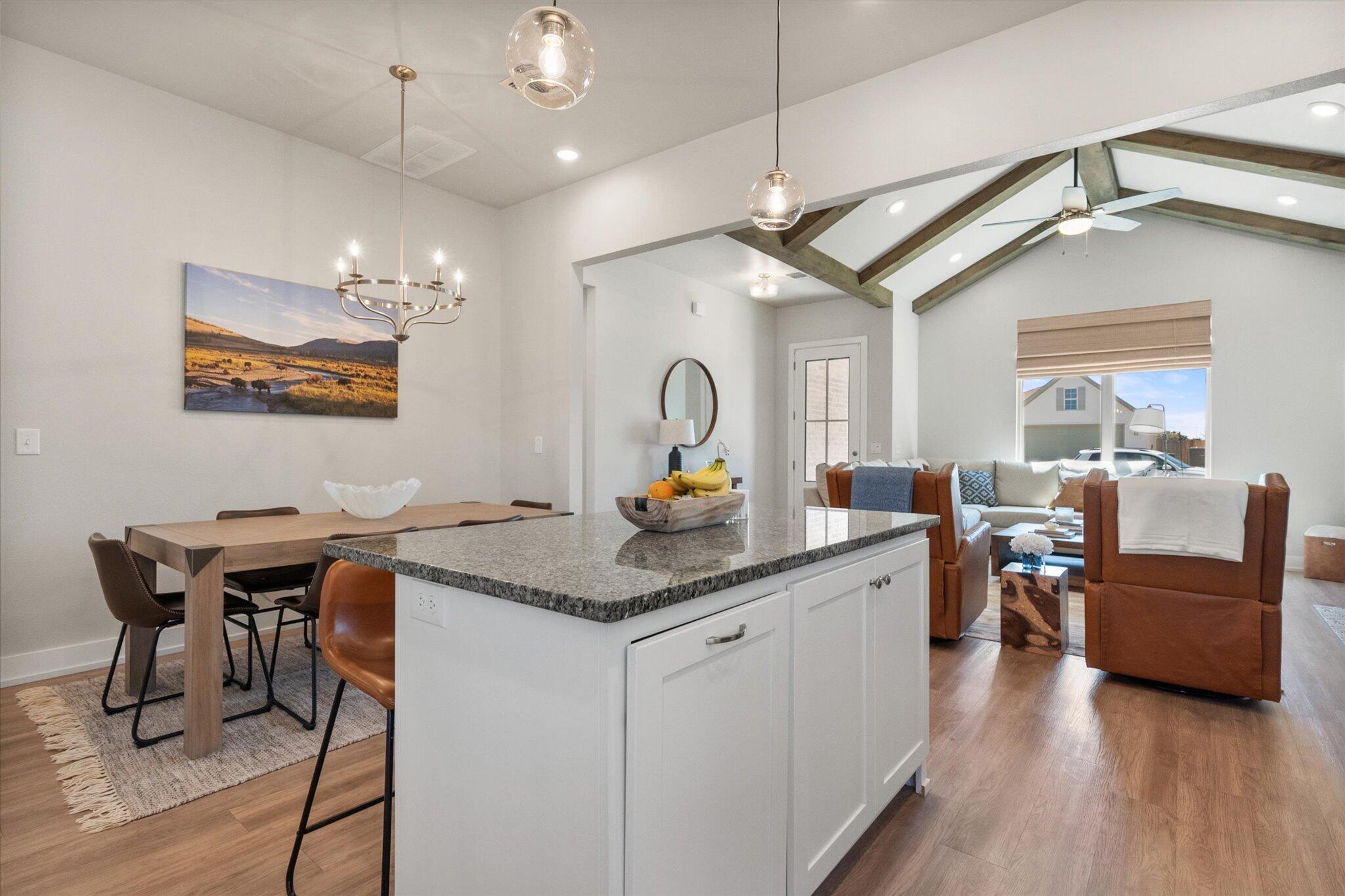 5908 Grinnell Street Lubbock, TX 79416 - Photo 10 of 27 a kitchen with a table chairs stove and wooden floor