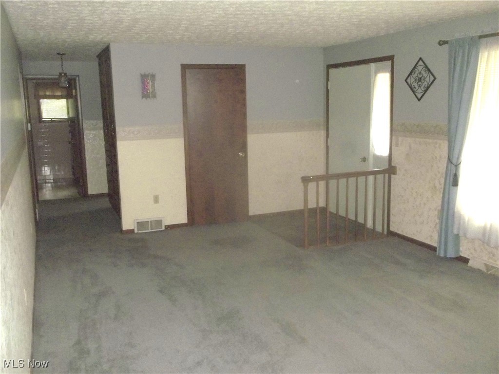 373 May Valley Road Southwest New Philadelphia, OH 44663 - Photo 25 of 38 Carpeted empty room featuring a healthy amount of sunlight