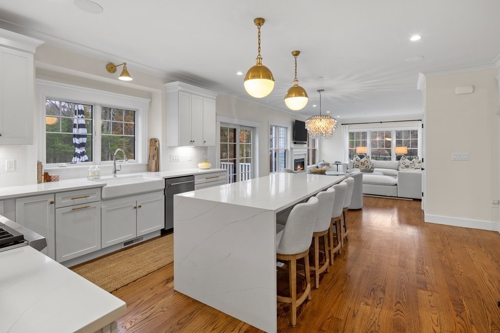 2 Five Paths Wayland, MA 01778 - Photo 9 of 26 a large kitchen with a center island wooden floor stainless steel appliances and a large window