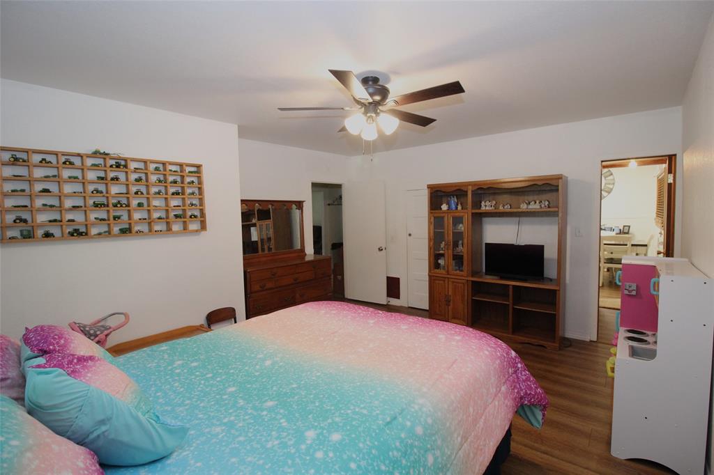 220 North 14th Avenue Munday, TX 76371 - Photo 18 of 34 a bedroom with a bed and a flat screen tv
