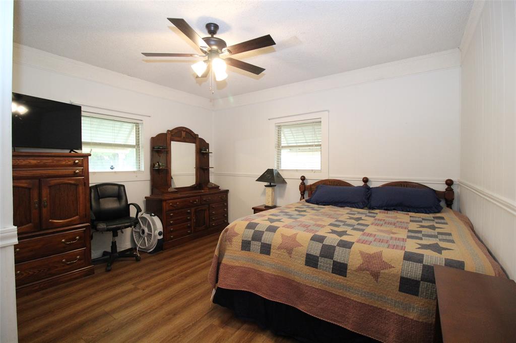 220 North 14th Avenue Munday, TX 76371 - Photo 20 of 34 a bedroom with a bed and a flat screen tv