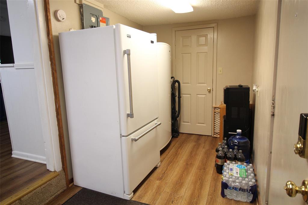 220 North 14th Avenue Munday, TX 76371 - Photo 24 of 34 a white refrigerator freezer sitting inside of a kitchen