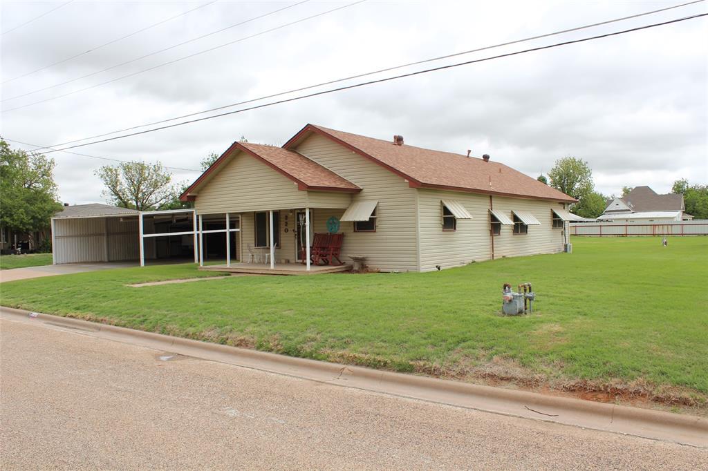 220 North 14th Avenue Munday, TX 76371 - Photo 4 of 34 a view of a house with a yard and a garden