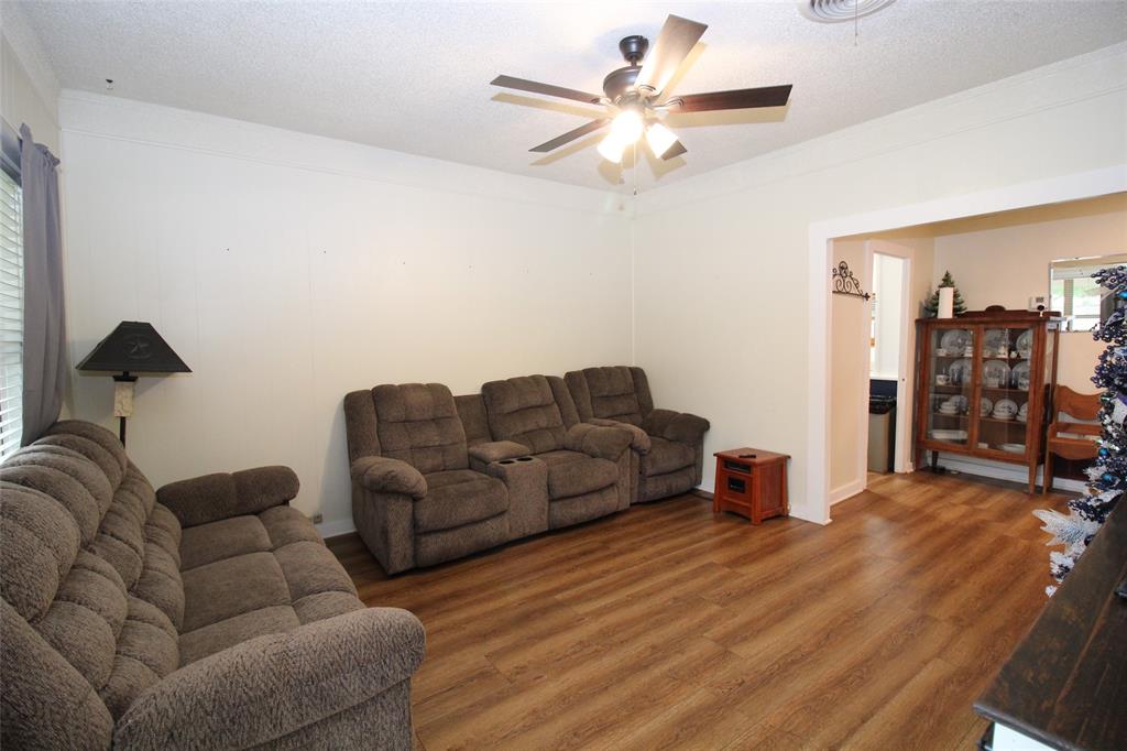 220 North 14th Avenue Munday, TX 76371 - Photo 7 of 34 a living room with furniture and a chandelier