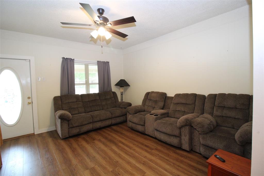 220 North 14th Avenue Munday, TX 76371 - Photo 8 of 34 a living room with couches a large window with outer view