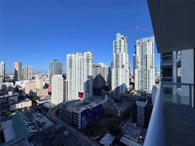 a bed sitting in a bedroom next to a large window