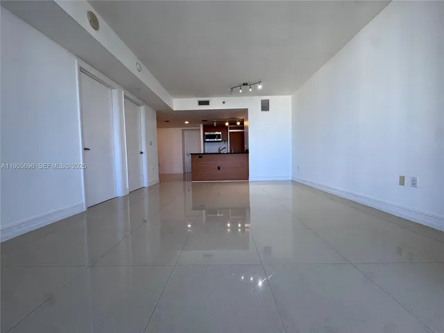 an empty room with sliding glass door