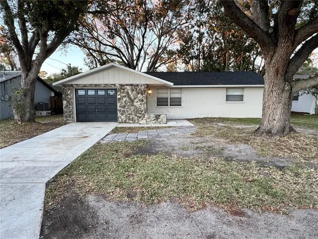 a front view of house with yard and trees