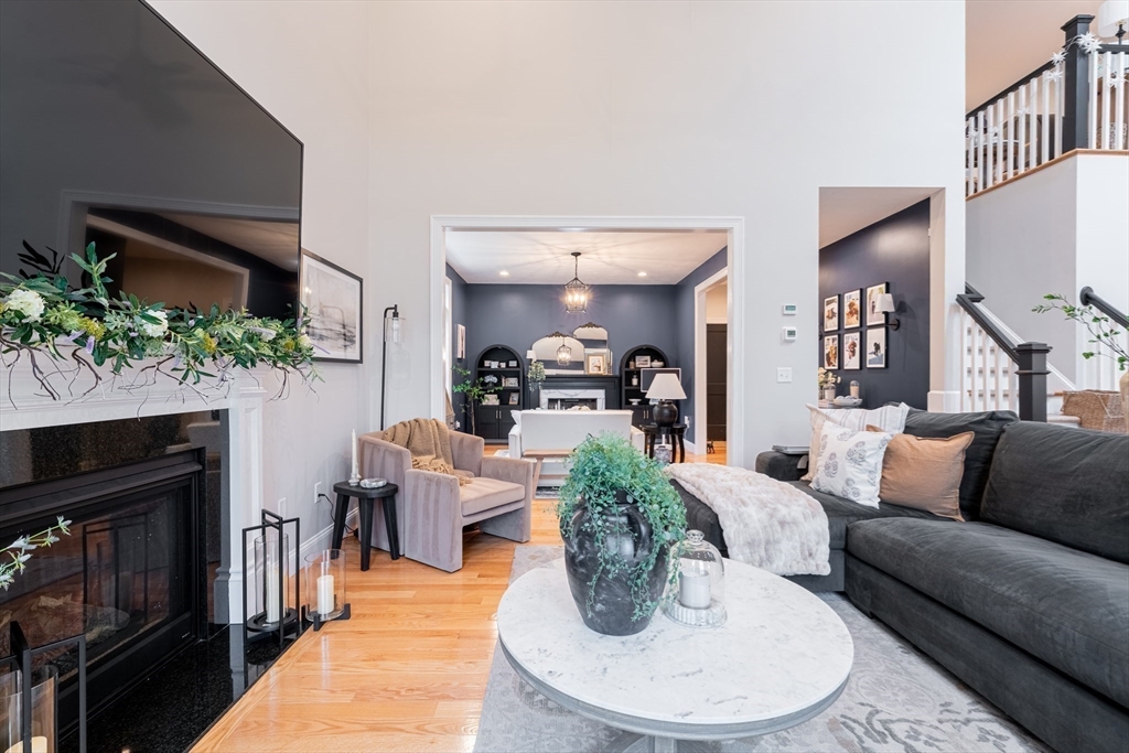 38 Cherry Street, Unit B Hudson, MA 01749 - Photo 12 of 33 a living room with furniture potted plant and a fireplace