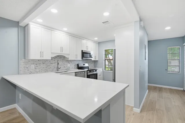 a kitchen with a sink a stove and refrigerator