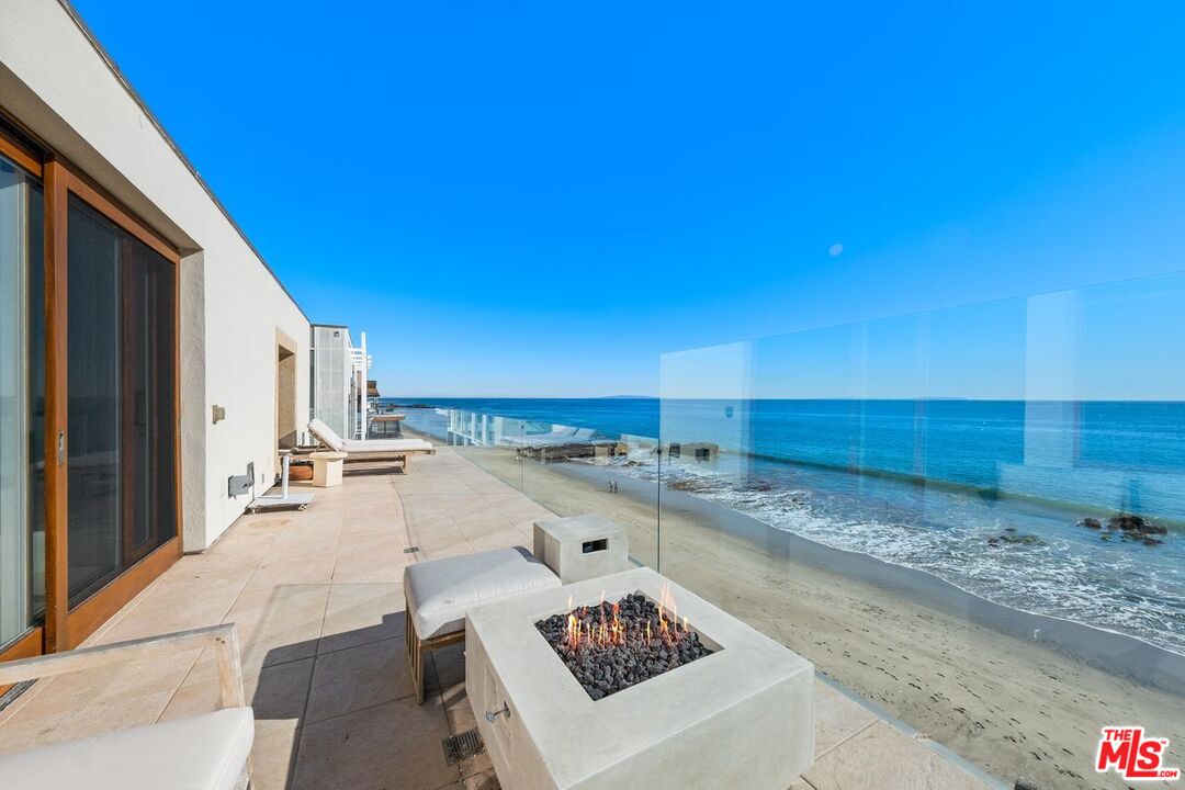 25302 Malibu Road Malibu, CA 90265 - Photo 19 of 36 a view of a patio with a table and chairs