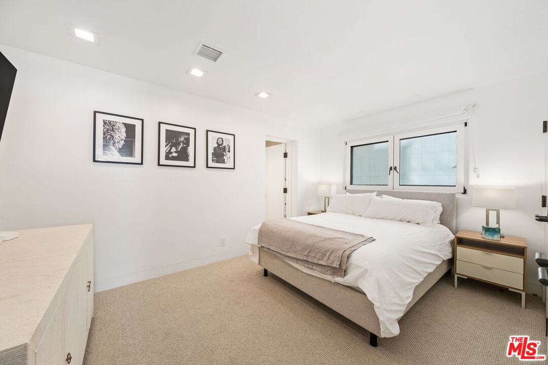 25302 Malibu Road Malibu, CA 90265 - Photo 26 of 36 a bedroom with a bed and a painting