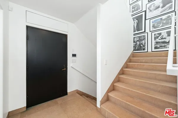 a view of staircase with white walls and windows