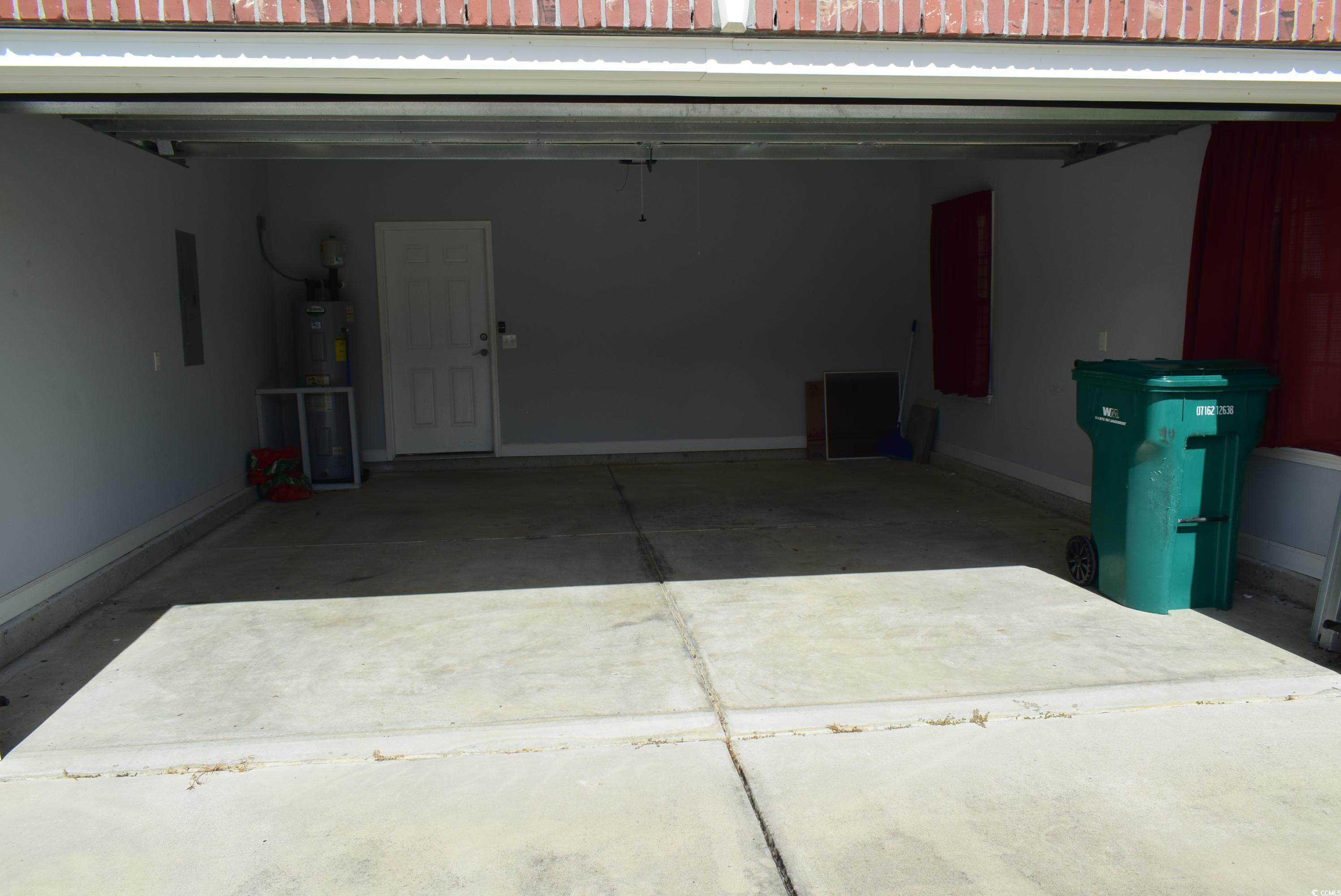 216 Rose Water Loop Myrtle Beach, SC 29588 - Photo 24 of 40 Garage featuring baseboards and electric panel