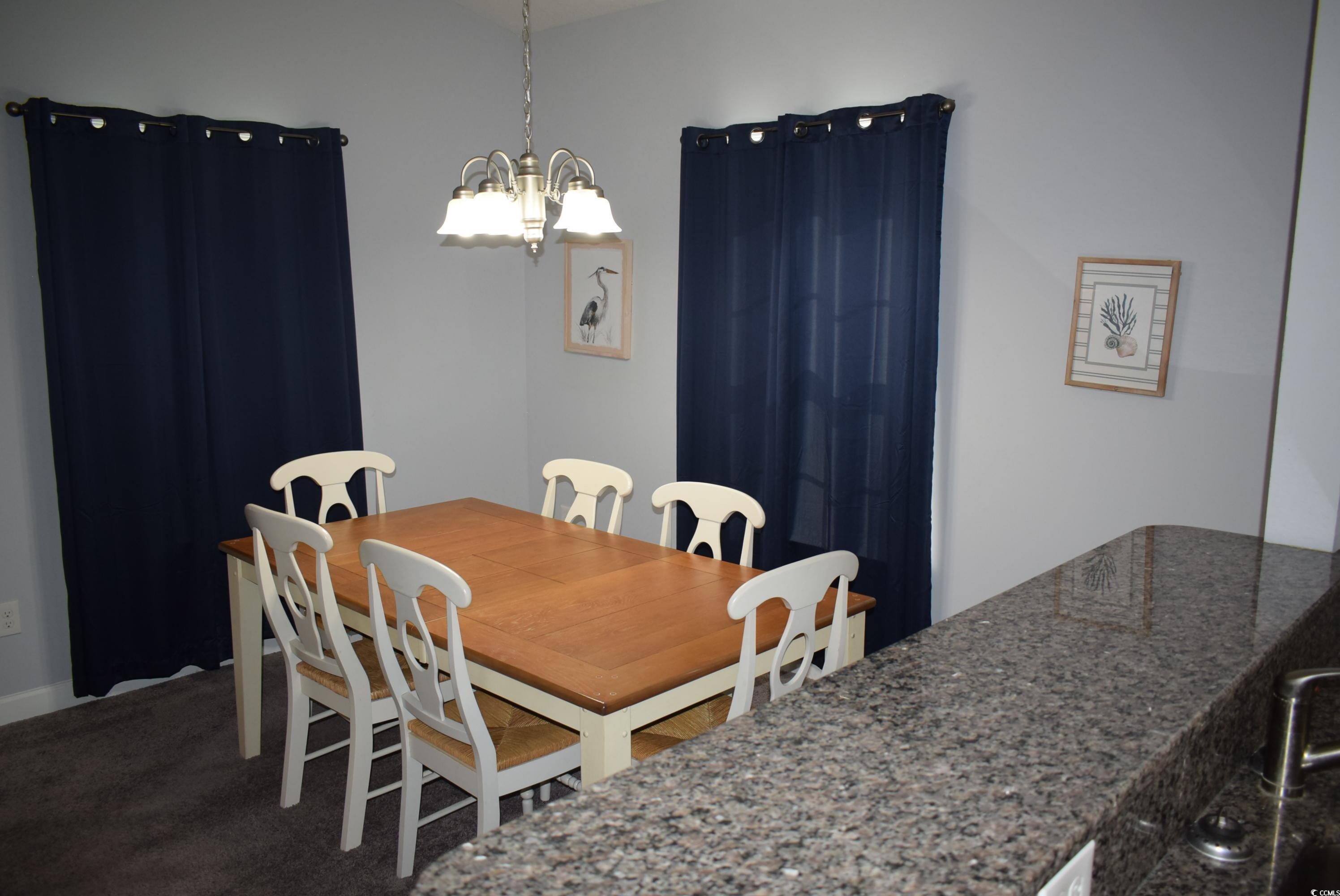 216 Rose Water Loop Myrtle Beach, SC 29588 - Photo 9 of 40 Carpeted dining area featuring a chandelier