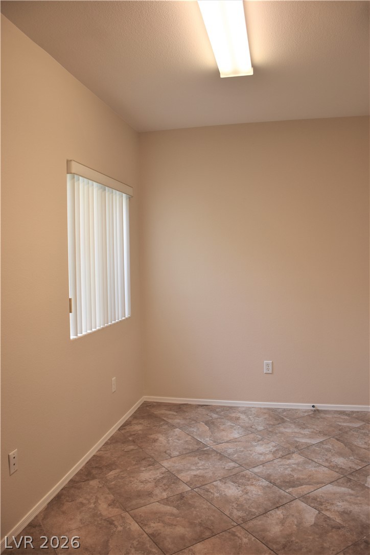 1680 Fieldbrook Street Henderson, NV 89052 - Photo 14 of 32 Durable tile flooring and a large window make this versatile room ideal for many uses.