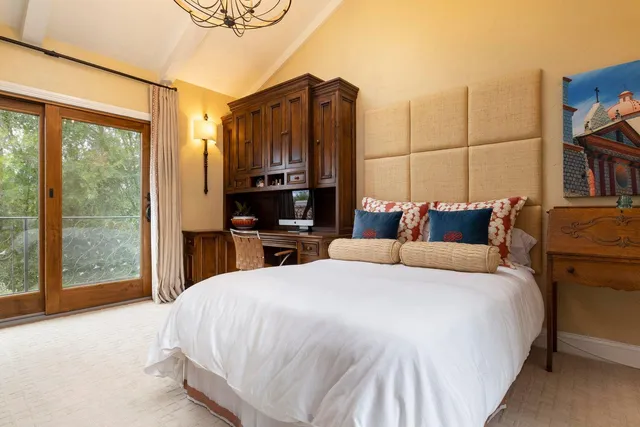 a spacious bedroom with a bed and a large window