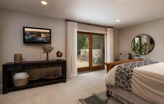 a bedroom with a bed and a flat screen tv