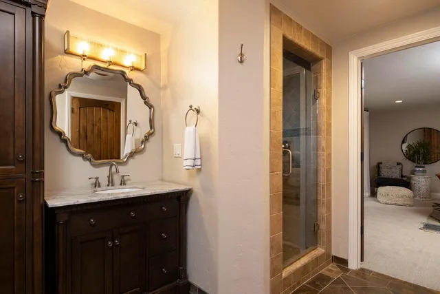 a en suite bathroom with a sink and a mirror