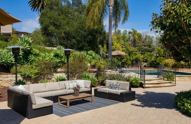 a view of a patio with couches and a fire pit