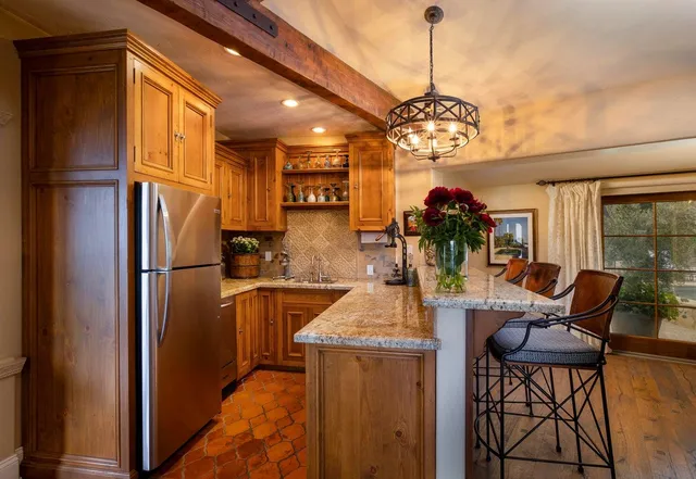a kitchen with refrigerator and cabinets