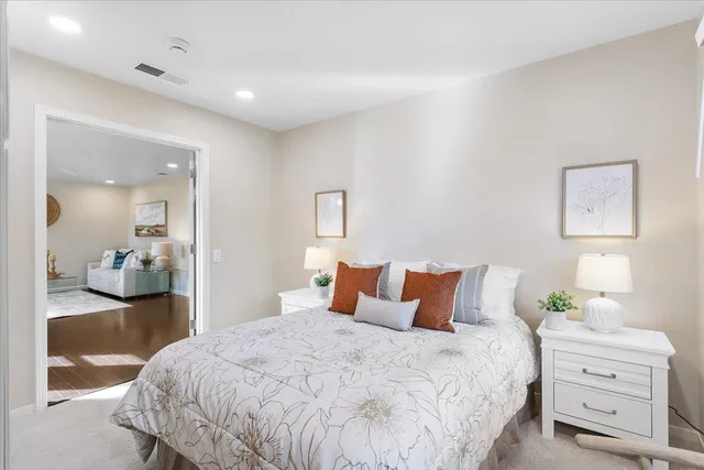 a bedroom with a bed and a large window