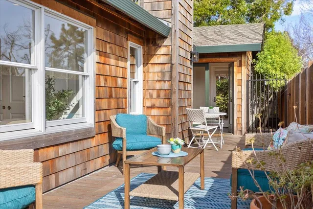 a backyard of a house with table and chairs