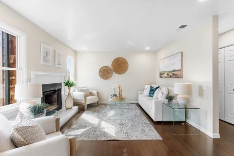 a living room with furniture and wooden floor