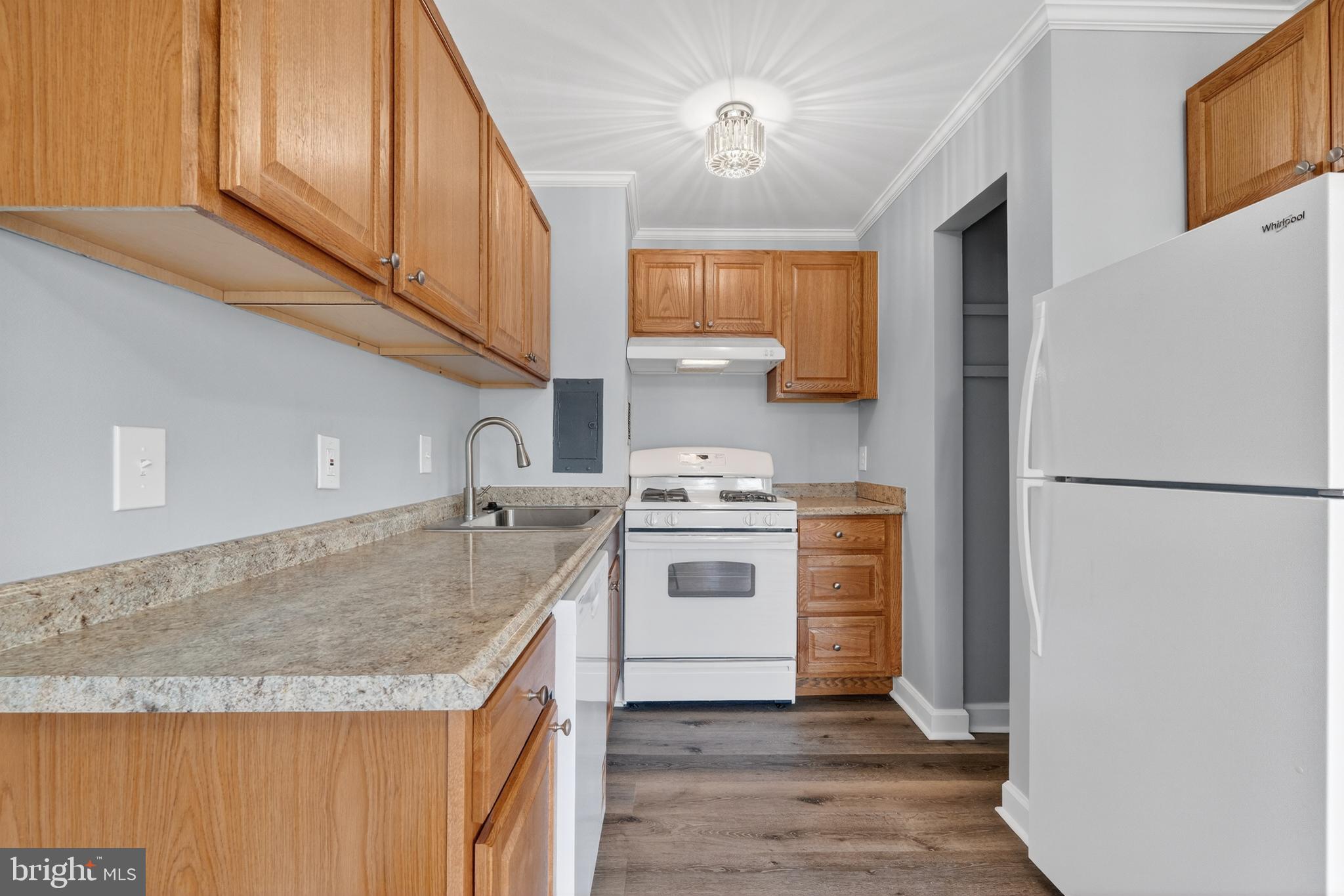 1804 Metzerott Road, Unit 504 Silver Spring, MD 20903 - Photo 13 of 24 a kitchen with a stove a sink and a refrigerator