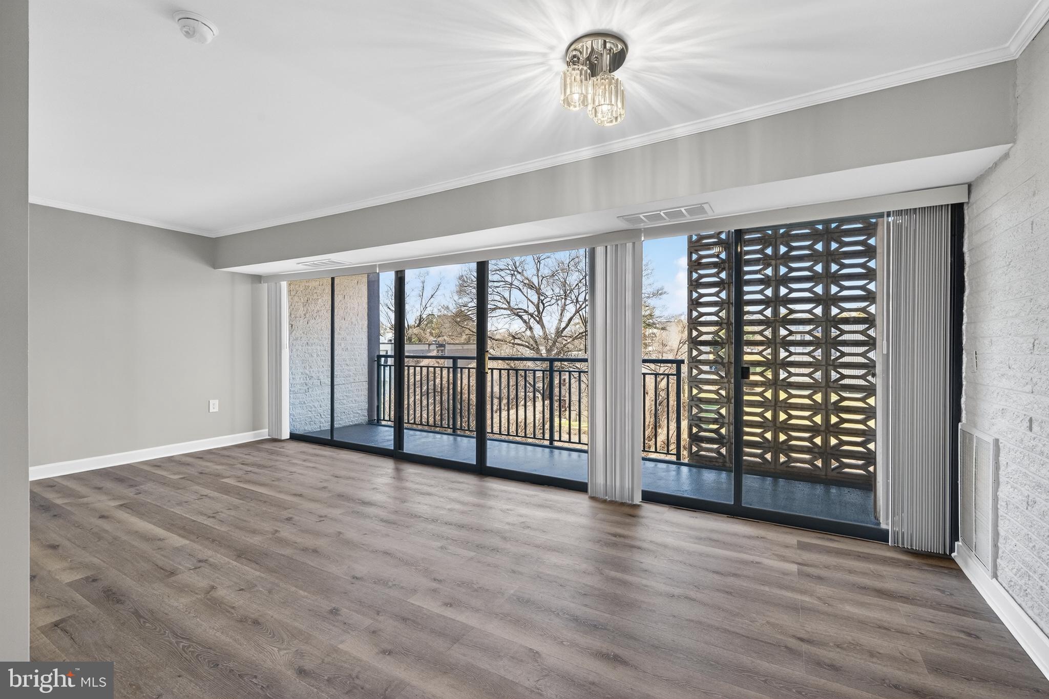 1804 Metzerott Road, Unit 504 Silver Spring, MD 20903 - Photo 16 of 24 wooden floor in an empty room with a window