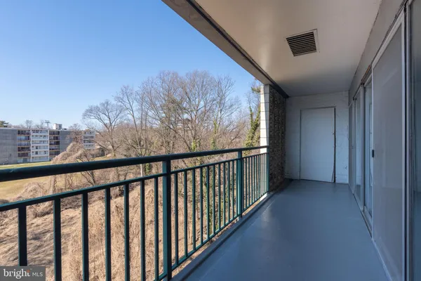 a view of a balcony with wooden floor