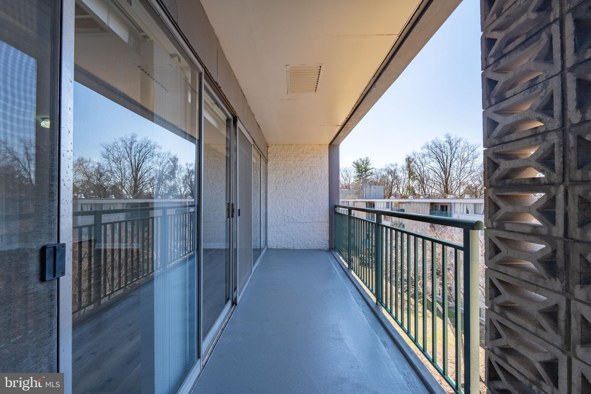 1804 Metzerott Road, Unit 504 Silver Spring, MD 20903 - Photo 19 of 24 a view of a balcony with wooden floor