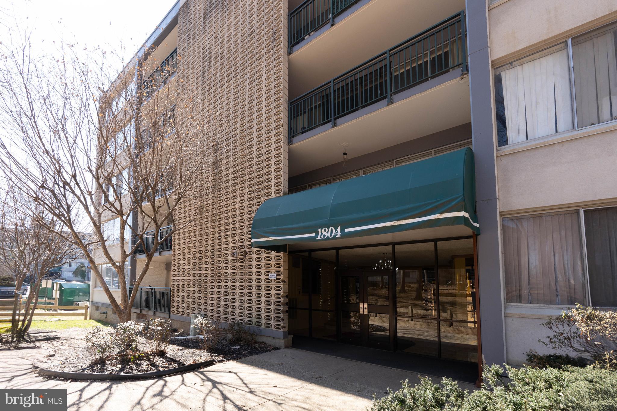 1804 Metzerott Road, Unit 504 Silver Spring, MD 20903 - Photo 3 of 24 a front view of a house with a garden