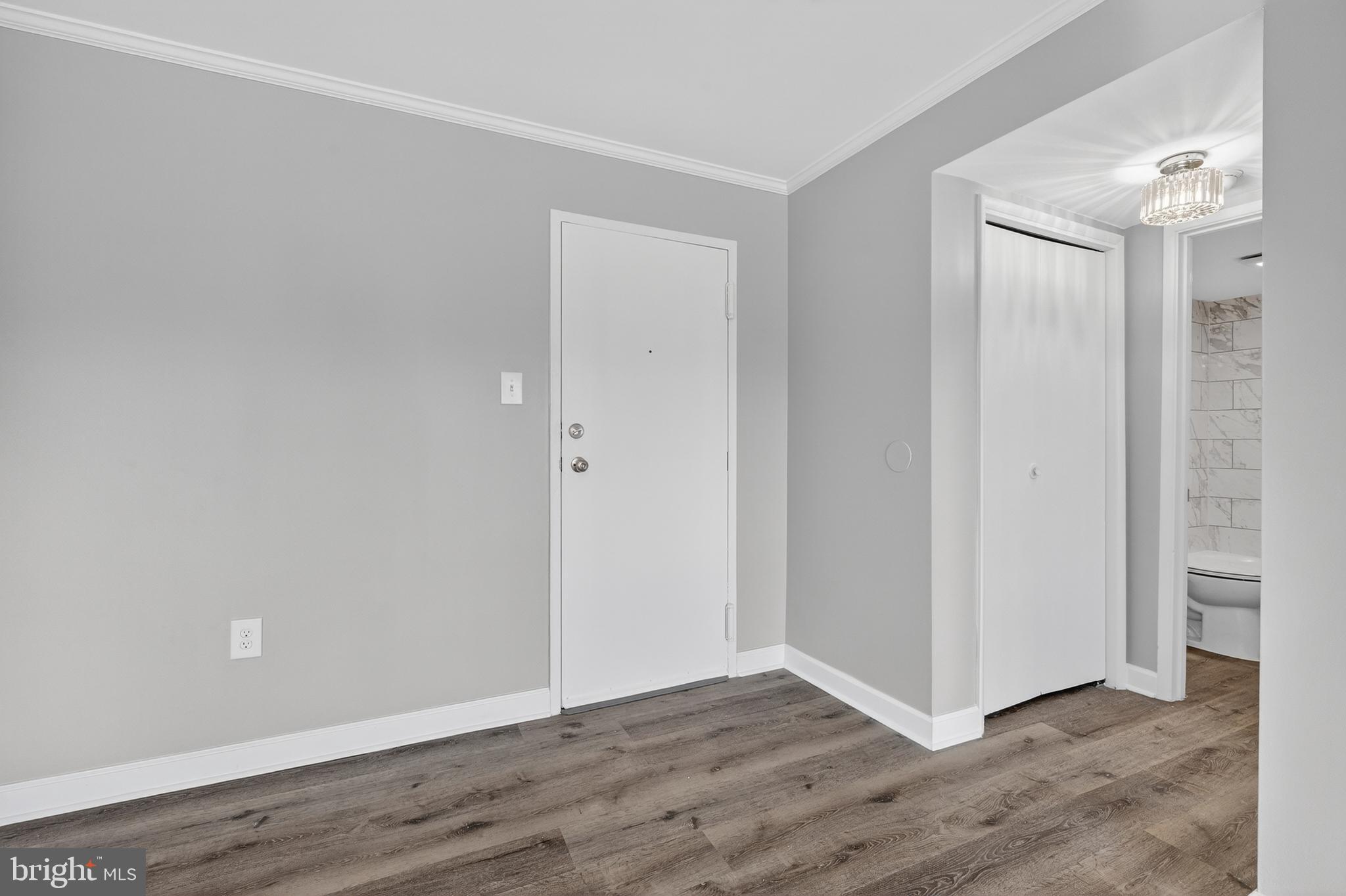 1804 Metzerott Road, Unit 504 Silver Spring, MD 20903 - Photo 6 of 24 a view of an empty room with wooden floor and closet