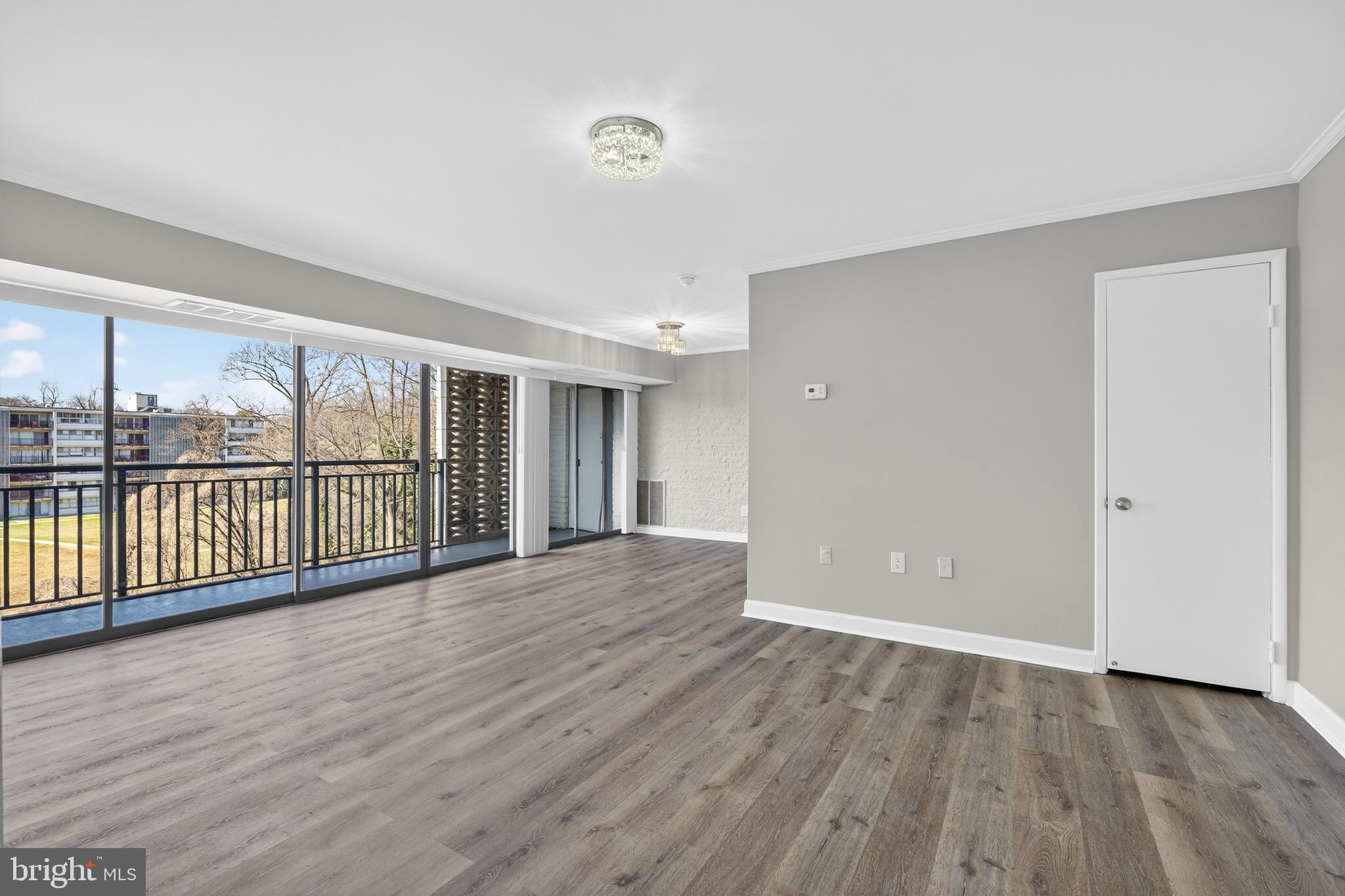 1804 Metzerott Road, Unit 504 Silver Spring, MD 20903 - Photo 7 of 24 an empty room with wooden floor and windows