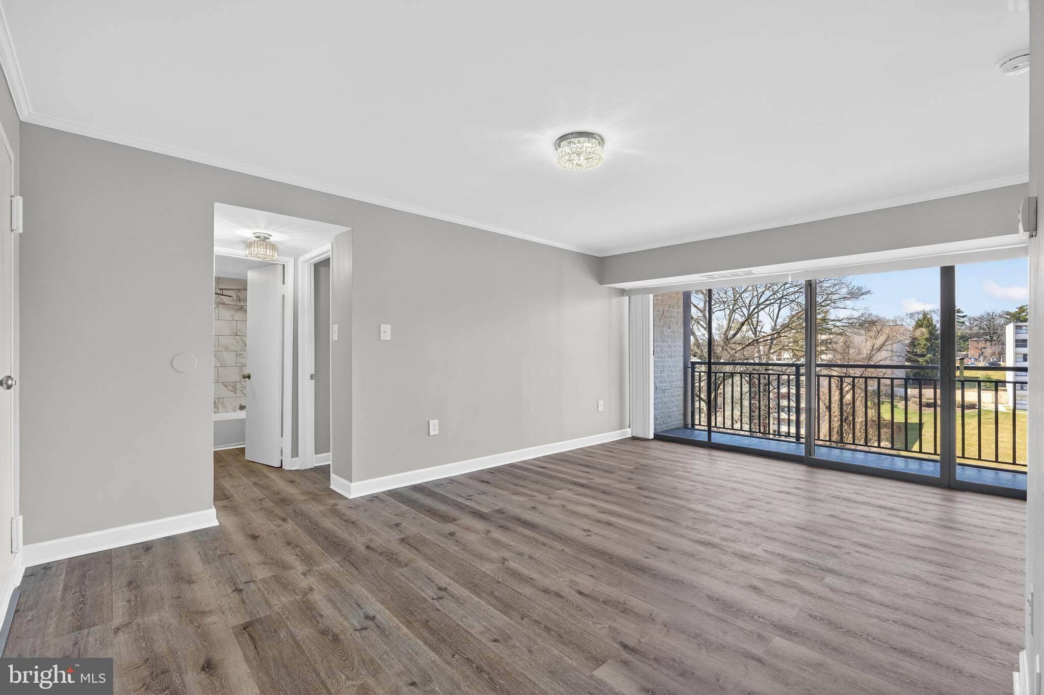 1804 Metzerott Road, Unit 504 Silver Spring, MD 20903 - Photo 8 of 24 wooden floor in an empty room with a window
