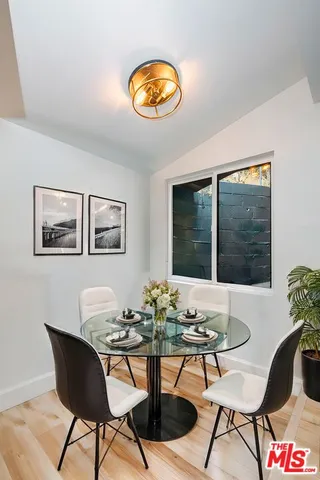 a view of a dining room with furniture and window