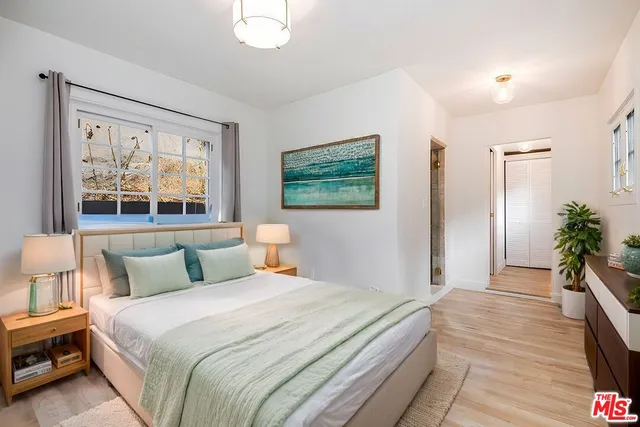 a bedroom with a large bed and a large window