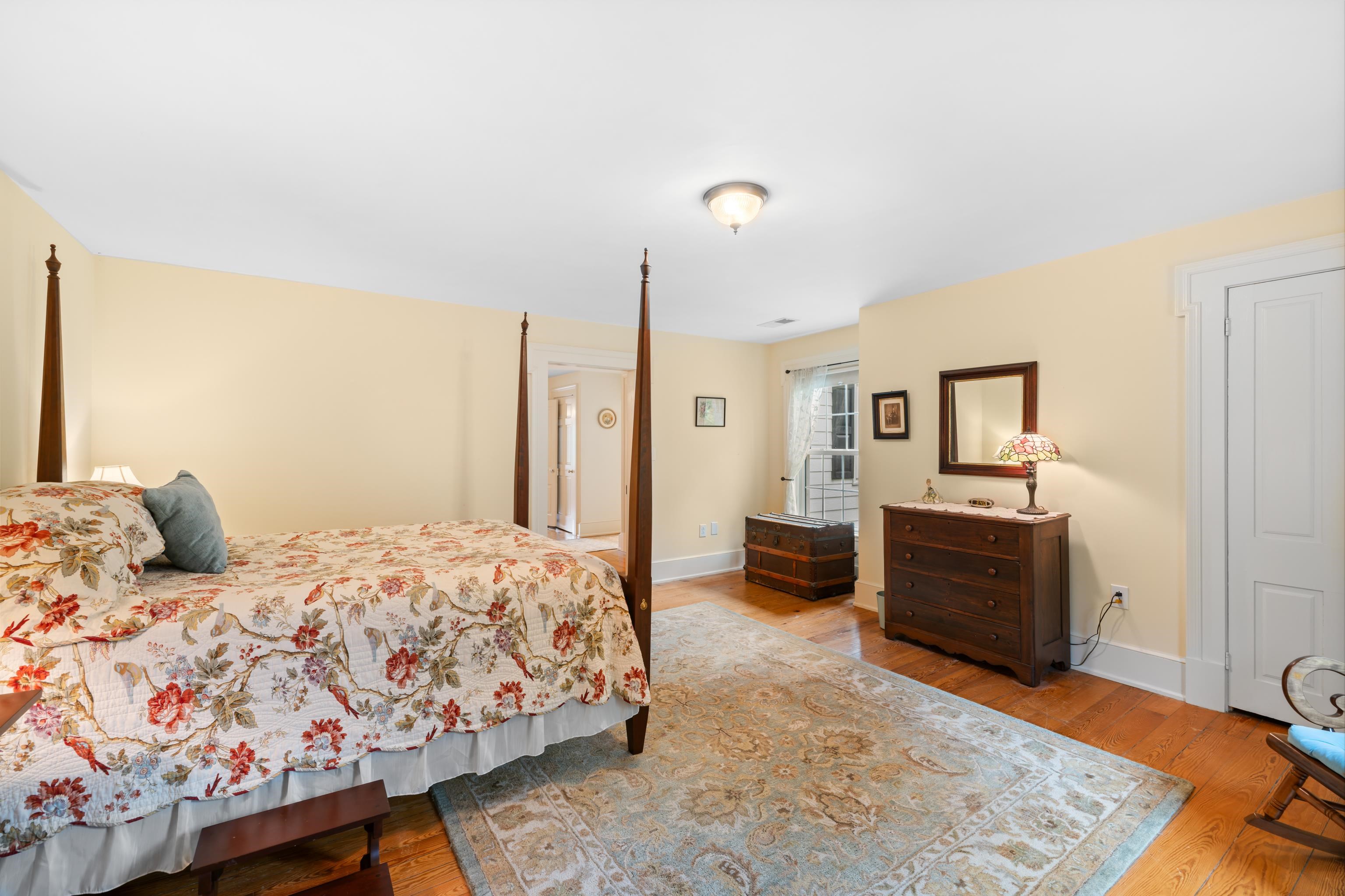 1202 Walkers Creek Road Middlebrook, VA 24459 - Photo 37 of 74 a bedroom with a large bed and a wooden floor