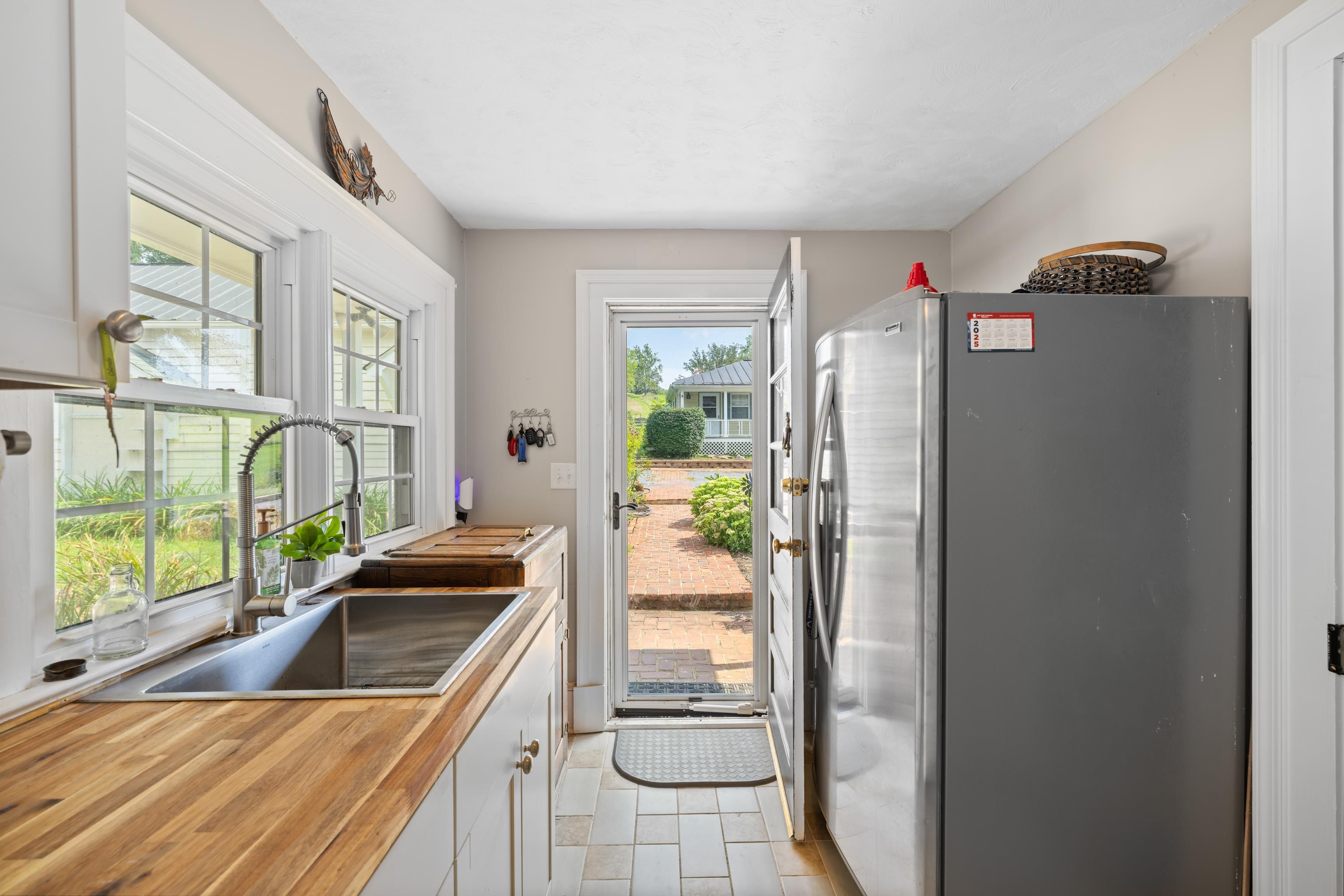 1202 Walkers Creek Road Middlebrook, VA 24459 - Photo 43 of 74 a kitchen with a refrigerator and a sink