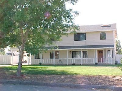 12410 Reata Road Apple Valley, CA 92308 - Photo 1 of 1 a front view of a house with a yard and trees