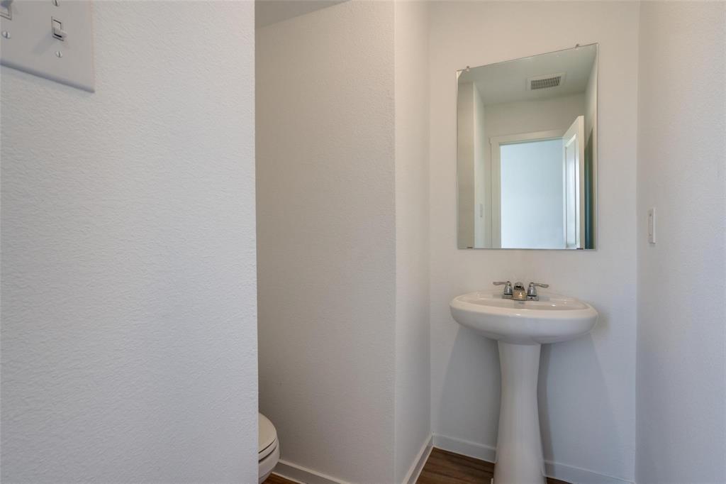 4237 Haflinger Road Providence Village, TX 76227 - Photo 14 of 14 a bathroom with a sink and a mirror