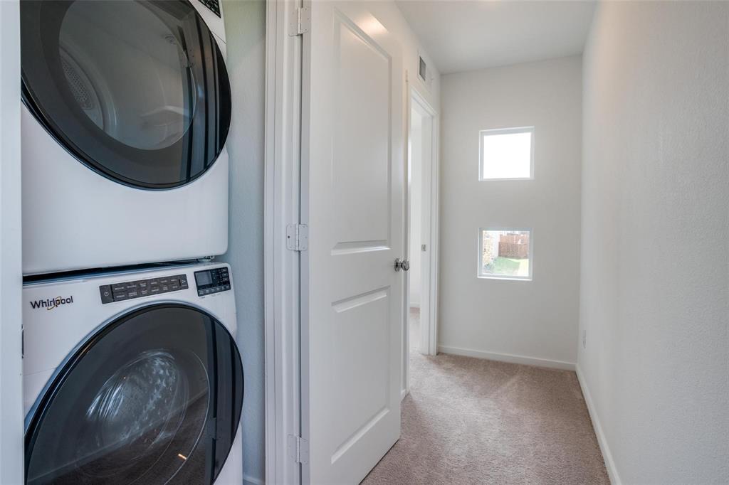 4237 Haflinger Road Providence Village, TX 76227 - Photo 8 of 14 a view of a hallway with washer and dryer