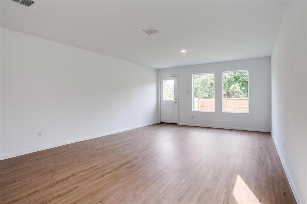 4237 Haflinger Road Providence Village, TX 76227 - Photo 10 of 14 an empty room with wooden floor and windows