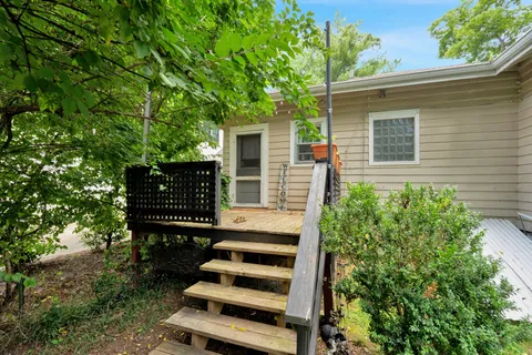 a view of a chairs setting in the back yard