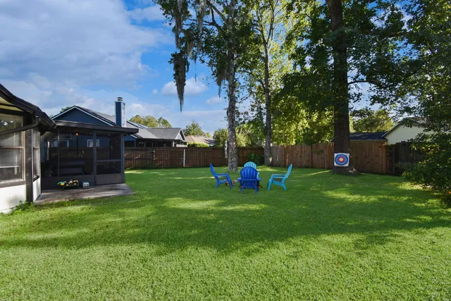 a view of a house with a backyard and a slide