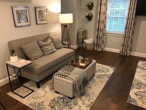 685 Pond Street, Unit B Franklin, MA 02038 - Photo 1 of 11 a living room with furniture and wooden floor